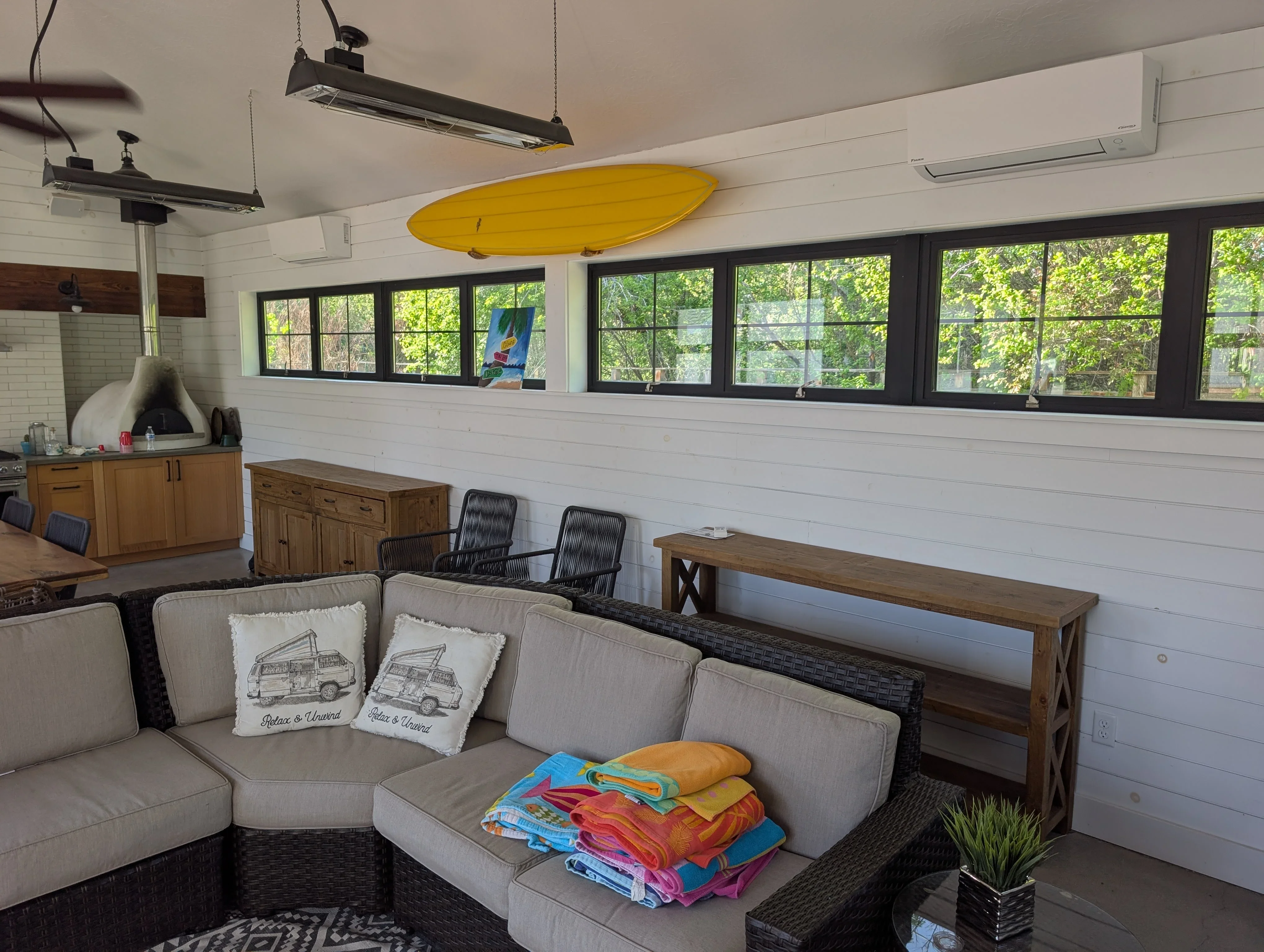 Ductless mini-split HVAC units installed on white shiplap walls with black-framed indoor air handlers