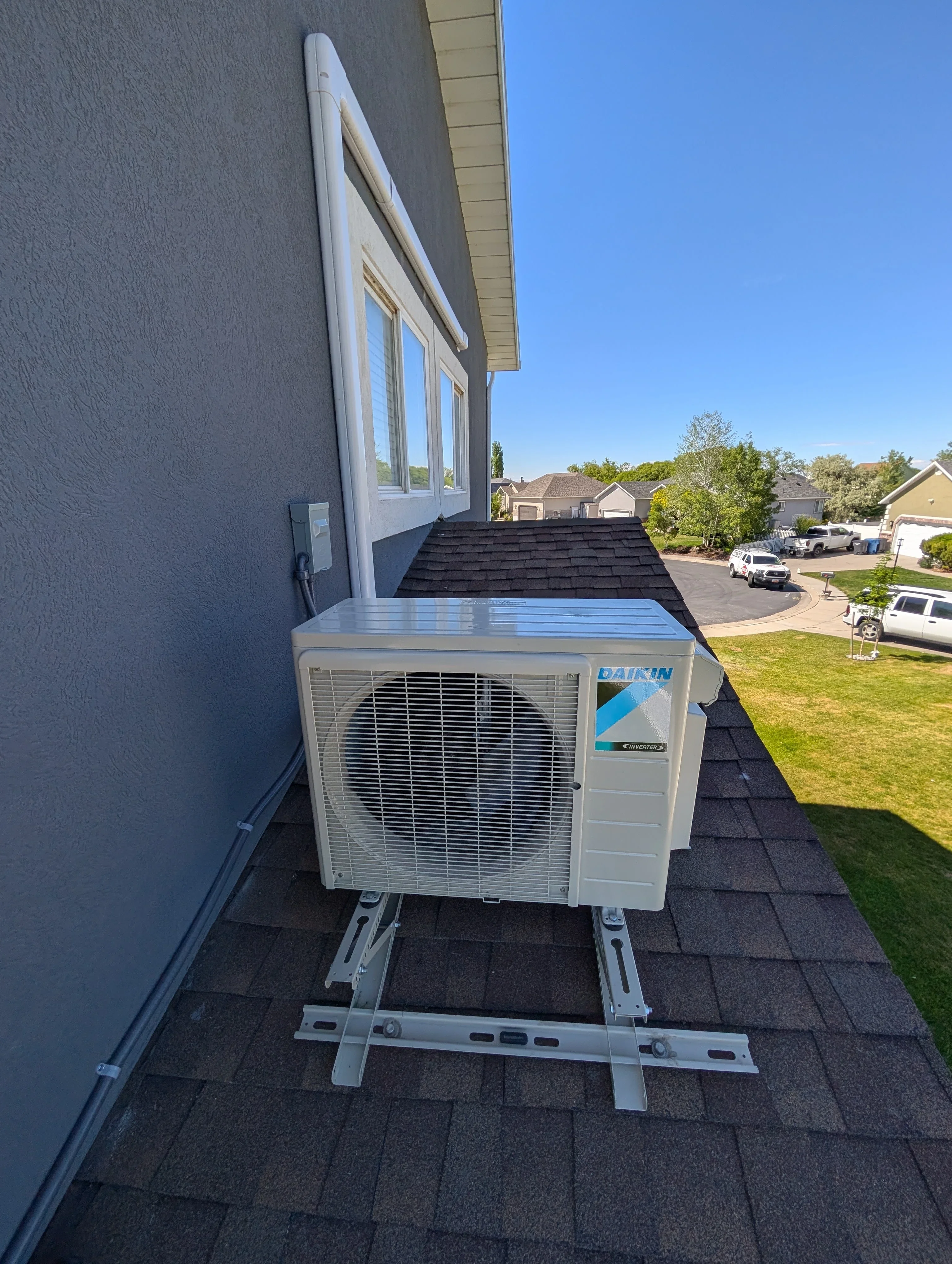 Daikin ductless mini-split outdoor condenser unit mounted on roof with metal bracket system