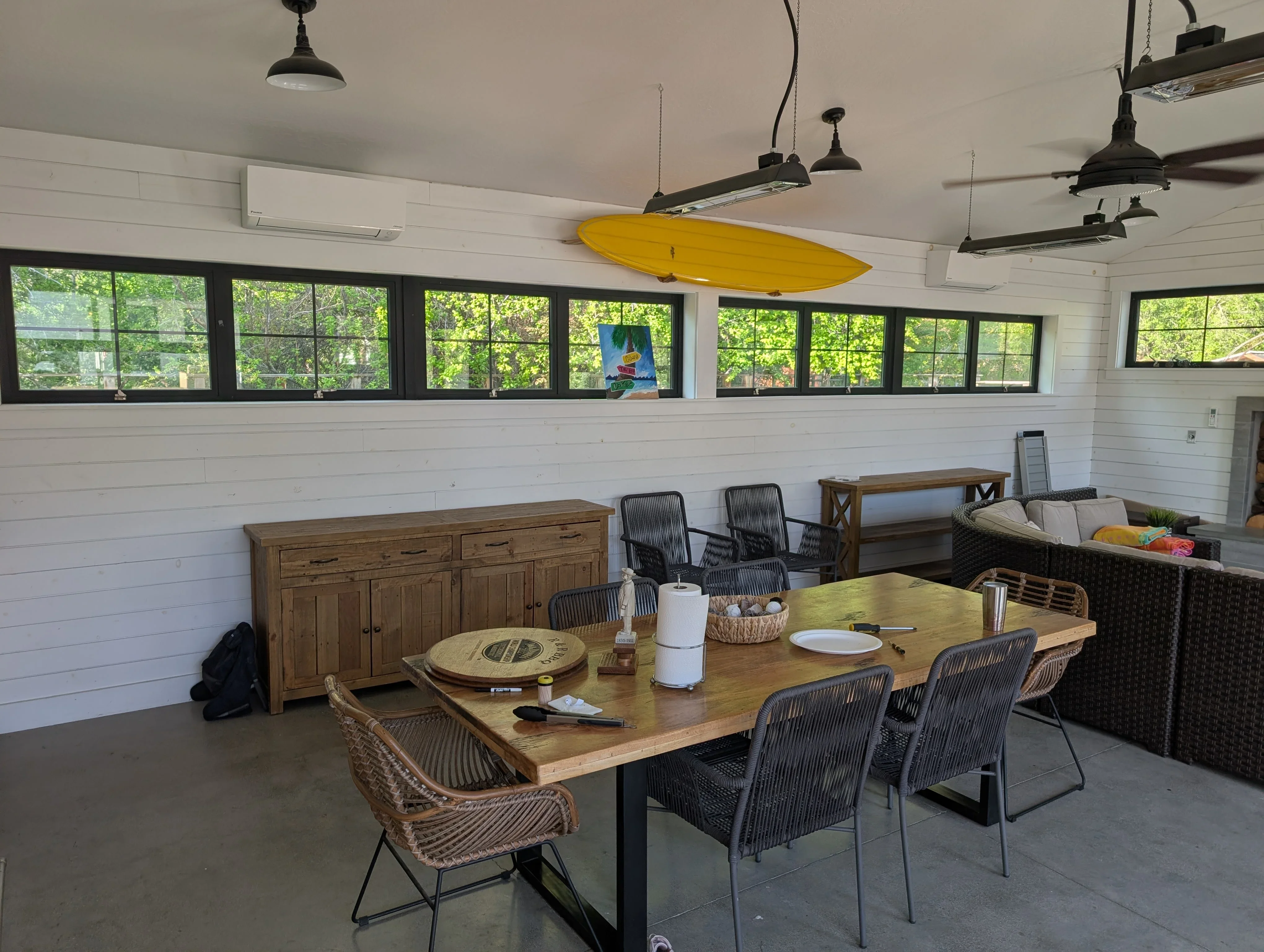 Ductless mini-split HVAC unit installed above white shiplap wall in modern lakehouse interior