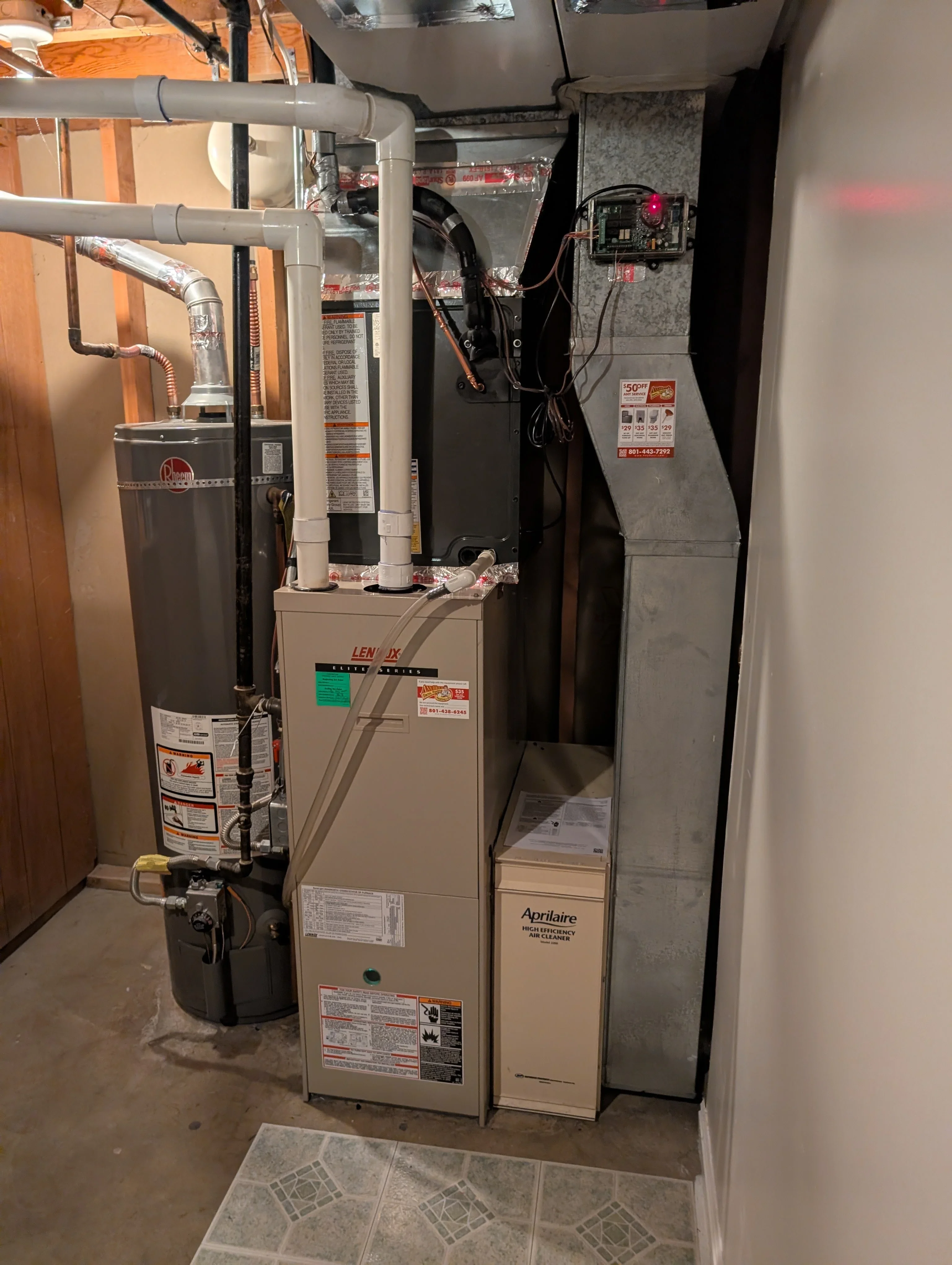 Lennox furnace with Aprilaire air cleaner, PVC ductwork, and control panel installation in utility space
